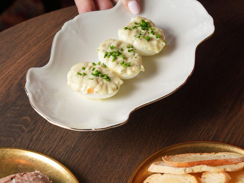 Oeuf mayonnaise with chives, served on ornate porcelain