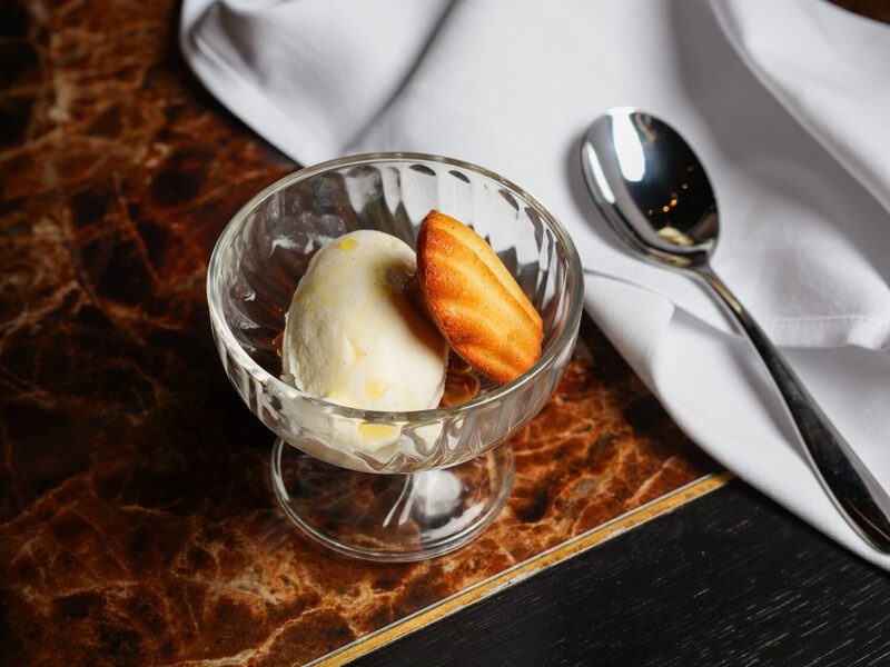 Vanilla ice cream with a madeleine in a glass coupe