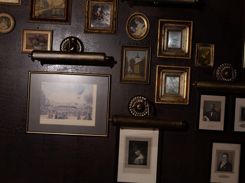 The wall of gilded frames and prints