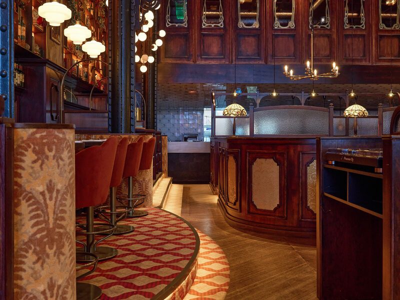 Art nouveau glass, opaline lamps and the curved bar of Chez van Rijn