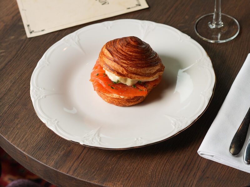 Salmon croissant with a champagne coupe on the Chez van Rijn menu